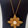 Broche pendentif Yves Saint Laurent en métal doré
