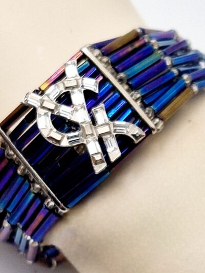Bracelet Yves Saint Laurent en perles, strass et métal argenté