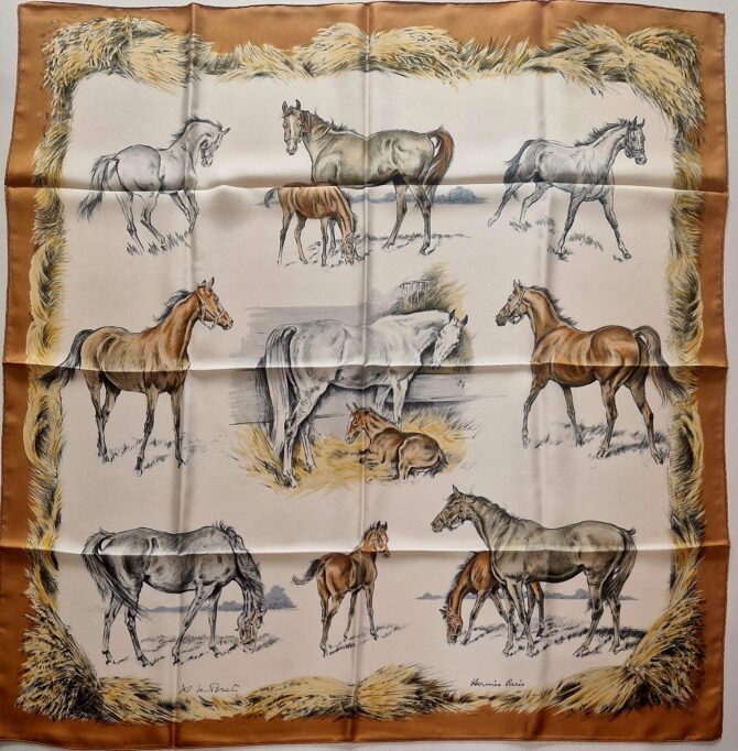 Carré Hermès en soie intitulé "Les Poulains" de Xavier de Poret, première édition 1960, illustrant des juments et poulains dans des scènes pastorales sur fond crème, encadré de bottes de foin dorées.