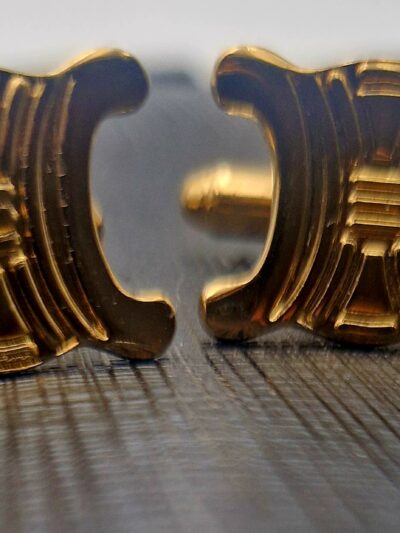 Boutons de manchette Céline dorés, motif Triomphe en relief.