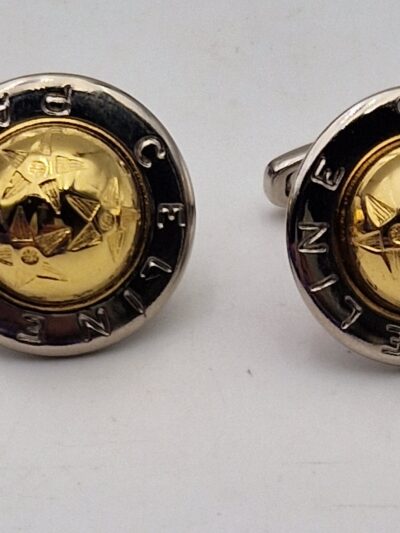 Boutons de manchette Céline or et argent vus de face, avec motif étoilé central.