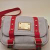 Sac Louis Vuitton Antigua Besace PM en toile beige avec sangles rouges et plaque Inventeur dorée EN : Louis Vuitton Antigua Besace PM in beige canvas with red straps and gold Inventeur plaque