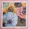 Carré Pierre Balmain en soie, motif fleurs pastel, bordure rose, 78 x 74 cm. EN : Pierre Balmain silk scarf, pastel flower design, pink border, 78 x 74 cm.