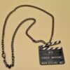 Pendentif Chanel “Coco Movie” en métal ruthénium et émail noir et blanc, collection Prêt-à-Porter Été 2005.