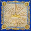 Foulard en soie bleu et or « La Grande Écurie du Roy – Versailles » signé Jacques Portier, représentant trois chevaux solaires entourés de motifs baroques et de visages rayonnants